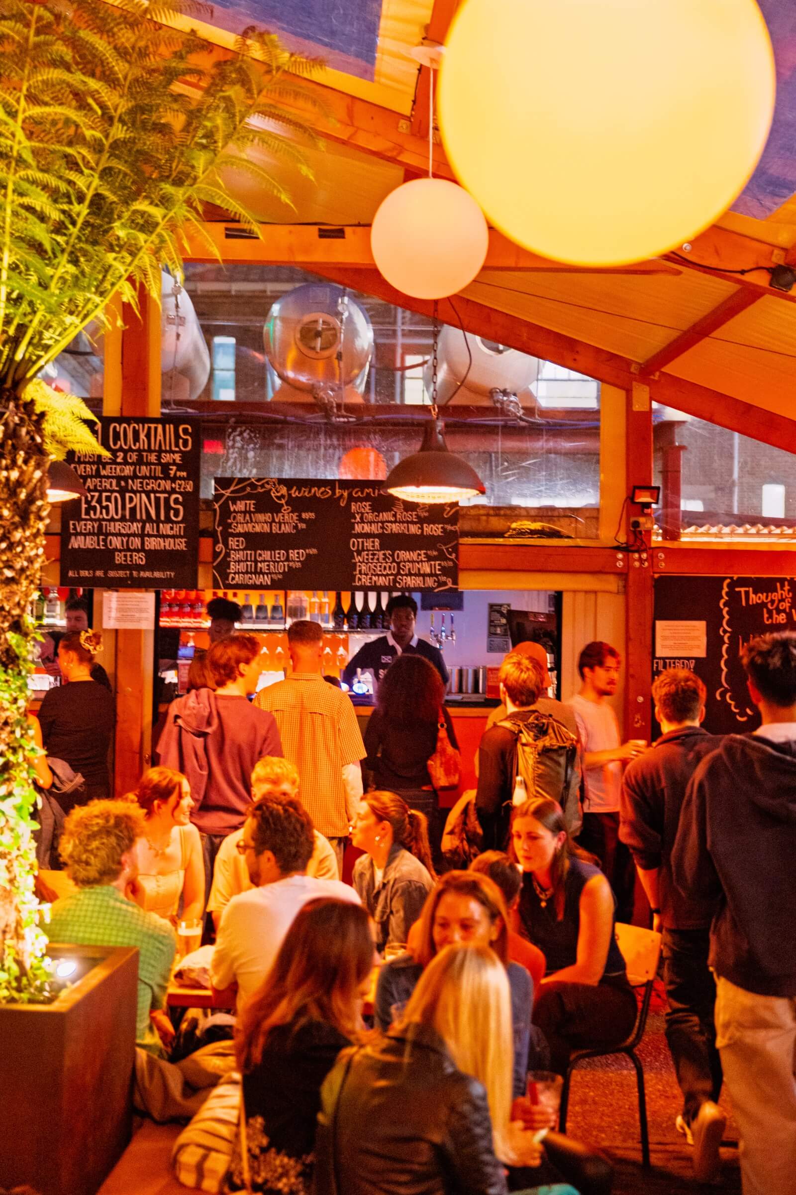 Image of people ordering at the bar while it's well lit