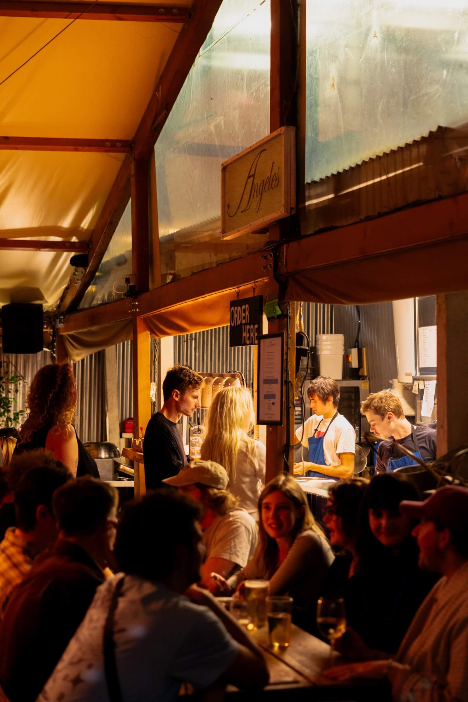 People ordering tacos at the kitchen of Peckham Arches